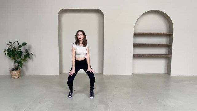 Elegant Woman Dancing in High Heels in Bright Studio
