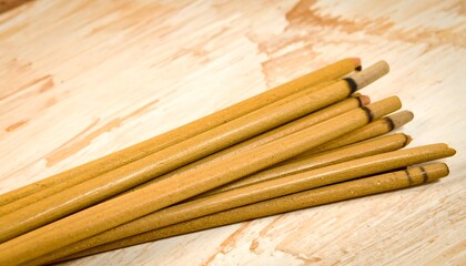 Stacked yellow sticks on wood
