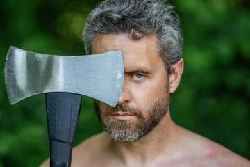 Man portrait with logging axe. Hardworking brutal man. Lumberjack hardworking outdoor. Brutal...