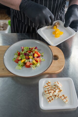 The chef lays out the salad. 