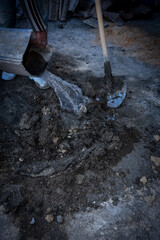 Worker pouring water into cement mixture