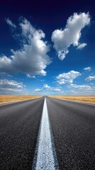 Naklejka premium Open road stretching into a vast, clear sky, filled with fluffy clouds, under a vibrant blue sky.