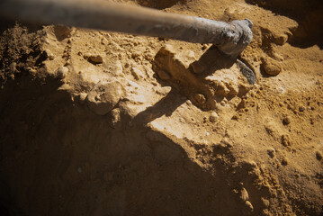 Pile of construction sand with shovel