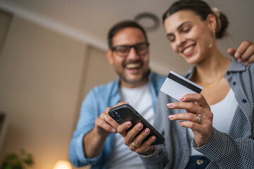 Couple using smart phone for online shopping and payment
