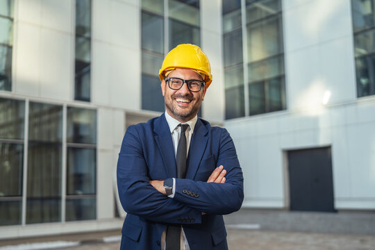 Confident male architect smiling wearing hard hat and suit - Powered by Adobe