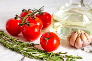 tomato with olive oil on wooden background