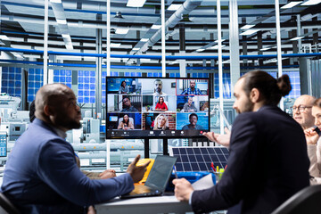 Businesspeople collaborate on sustainable energy investments, discussing with investors in videoconference. Photovoltaics factory company management executives doing online videocall meeting