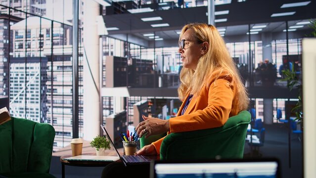 Diverse group of ambitious businesswomen engaged in a briefing meeting, focused on career progression within multinational company. Goals oriented women driving success, gender equality. Camera B.