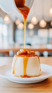 Pouring caramel sauce over creamy flan dessert in a cozy cafe setting