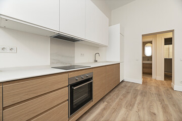 Minimalist kitchen with   quartz countertops, handleless cabinets, and a push-to-open system for a clean look