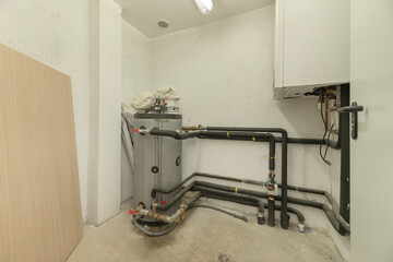 laundry room with a washer-dryer, compact boiler, and area to fold clothes immediately after washing