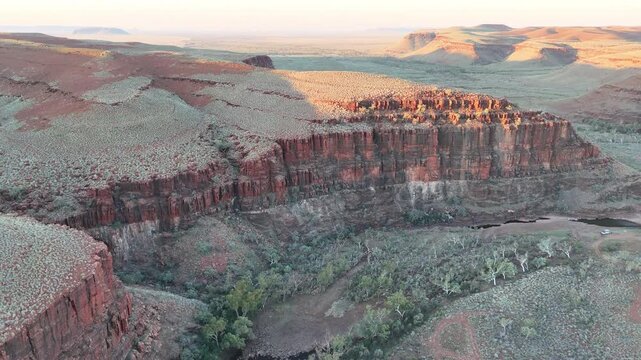 aerial drone shot of a remote bush camp along secluded George river in the beautiful red rolling hills of Millstream Chichester National Park, pilbara shire in West Australia.