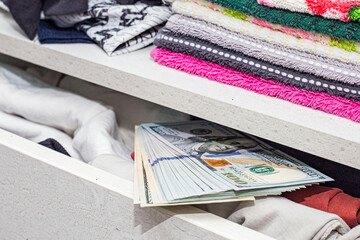 a stash of cash in a closet with underwear kept at home for emergencies