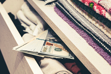 a stash of cash in a closet with underwear kept at home for emergencies