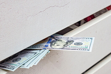 a stash of cash in a closet with underwear kept at home for emergencies