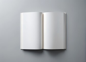 Naklejka premium An open blank book with white pages lies on a gray surface, ready for writing or drawing