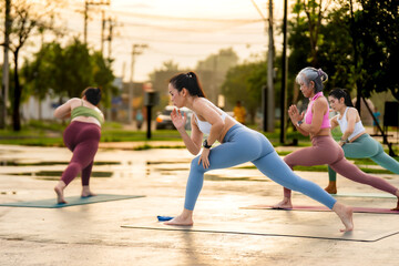 Women of different ages practicing warrior yoga pose outdoors, promoting health, wellness, and active lifestyle.