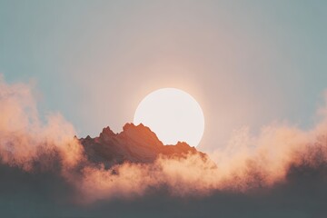 Sunrise over a mountain range shrouded in clouds