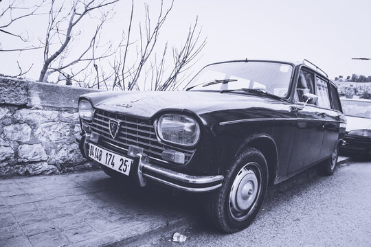 Vintage Peugeot 404 station wagon parked on a street in Constantine, Algeria, classic retro car photography