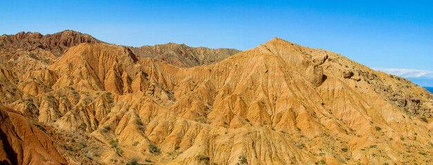 Colorful Fairytale rainbow canyon panorama landscape in Kyrgyzstan. Orange and yellow mountain...