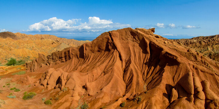 Colorful Fairytale rainbow canyon panorama landscape in Kyrgyzstan. Orange and yellow mountain valley Skazka canyon, rainbow mountain landscape all over the world in Pamir near Issyk Kul lake