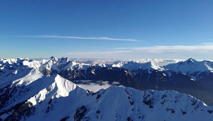 Snow-capped peaks and valleys under a clear blue sky