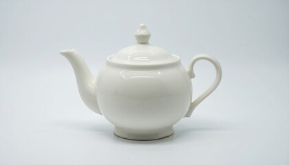 Simple white ceramic teapot with lid and curved handle on a clean, white background