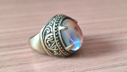 Elegant statement ring with iridescent stone and vintage-inspired band offers a touch of old-world glamour and whimsical charm for any occasion