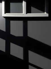 Abstract background, the shadow of a window frame cast on a dark surface. The strong contrast.