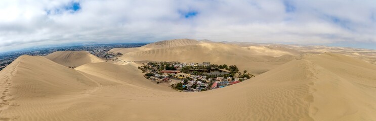 Oasis Huacachina high resolution wide angle panoramic landscape. Sand dunes dry desert in Peru....