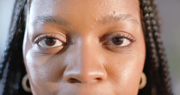 African American woman wearing earrings showing smirk emerging then full smile for modeling shoot