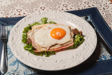 Milanesa with fried egg on a restaurant table.