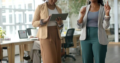 African American colleagues demoing by scrolling tablet while one gesturing in VR headset at office - Powered by Adobe