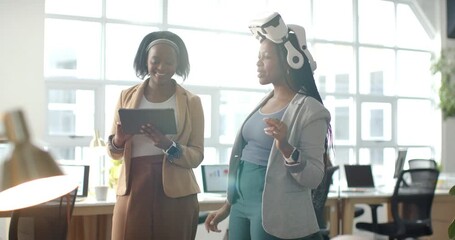 After colleague's gesture, African American colleagues testing VR headset with tablet in office - Powered by Adobe