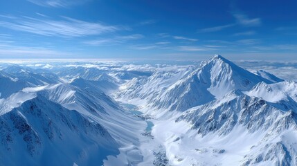 Obraz premium Snowy Mountain Peaks Under a Clear Blue Sky in Winter Landscape Aerial View with Sunlight Cold White and Grey Shades