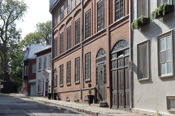 Naklejka premium A view in summer of the Old Quebec in Canada with ancient architecture. Panorama of the old Quebec with ancient building. Historic building in Quebec city. Tourism and destination. Old facade.
