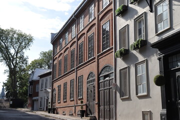 Naklejka premium A view in summer of the Old Quebec in Canada with ancient architecture. Panorama of the old Quebec with ancient building. Historic building in Quebec city. Tourism and destination. Old facade.