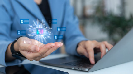 Businessman hand holding AI icon with digital human profiles, artificial intelligence recruitment, HR technology, talent acquisition, candidate searching, and personnel management concept.