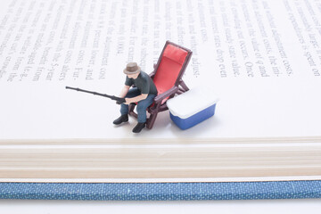 Tiny Model Hunter With Rifle Beside Blue Cooler