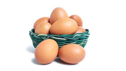 Stack of fresh chicken egg in green basket wicker bamboo. Isolated on white background with copy space. Suitable for editing and used for food and nutrition advertising. Clipping path.