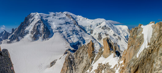 Mountain landscape of the Alps in Chamonix valley, France high resolution wide angle panoramic landscape. Alpine scenery in summer sunny weather on Tour du Mont Blanc, TMB trekking route