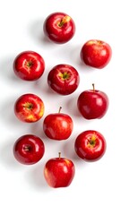 Red apples scattered on a white background, overhead shot