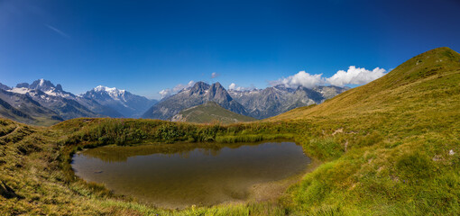 Mountain landscape of the Alps in Chamonix valley, France high resolution wide angle panoramic landscape. Alpine scenery in summer sunny weather on Tour du Mont Blanc, TMB trekking route