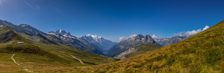Fototapeta premium Mountain landscape of the Alps in Chamonix valley, France high resolution wide angle panoramic landscape. Alpine scenery in summer sunny weather on Tour du Mont Blanc, TMB trekking route