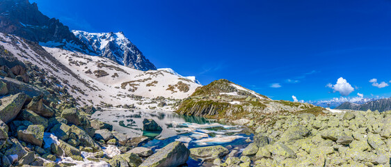 Mountain landscape of the Alps in Chamonix valley, France high resolution wide angle panoramic landscape. Alpine scenery in summer sunny weather on Tour du Mont Blanc, TMB trekking route
