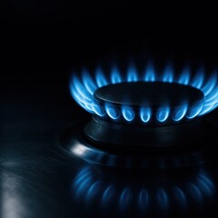 Blue gas burner flame on home kitchen stove in dark moody room panoramic banner concept for rising energy prices inflation and household budget stress