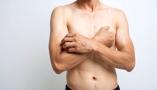 Shirtless man scratching his arm and chest against a white background
