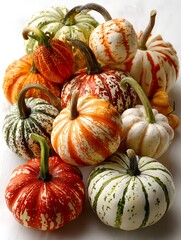 An arrangement of colorful ornamental gourds in various shapes and sizes is a beautiful autumn display.