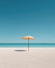 Solitary pale yellow beach umbrella casts a small shadow on a pristine white sand beach under a vibrant blue sky and calm turquoise ocean