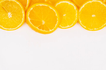 Row of vibrant orange slices forms upper border providing ample white copy space underneath.